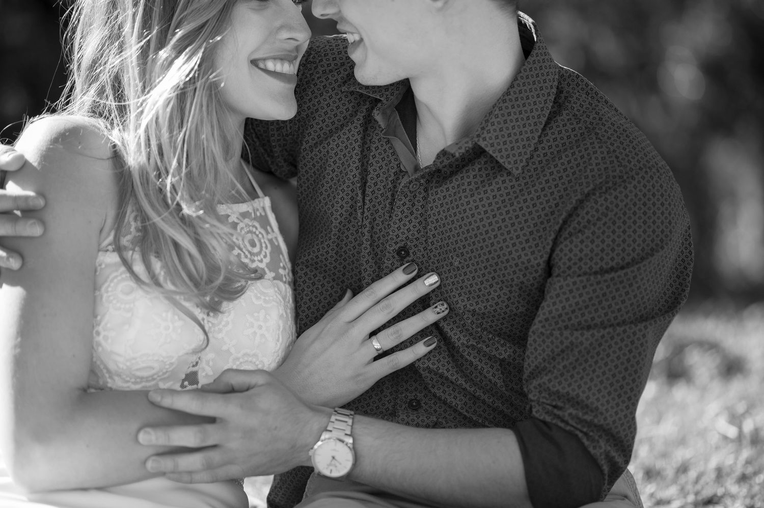 A black and white portrait captures an intimate moment between a couple.