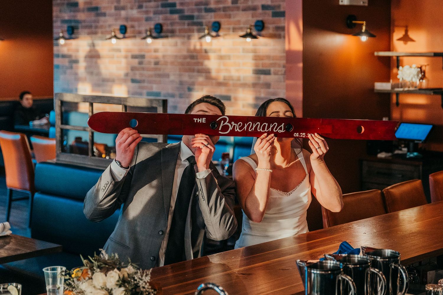 Motion blur of wedding party walking past couple sharing intimate moment outdoors.