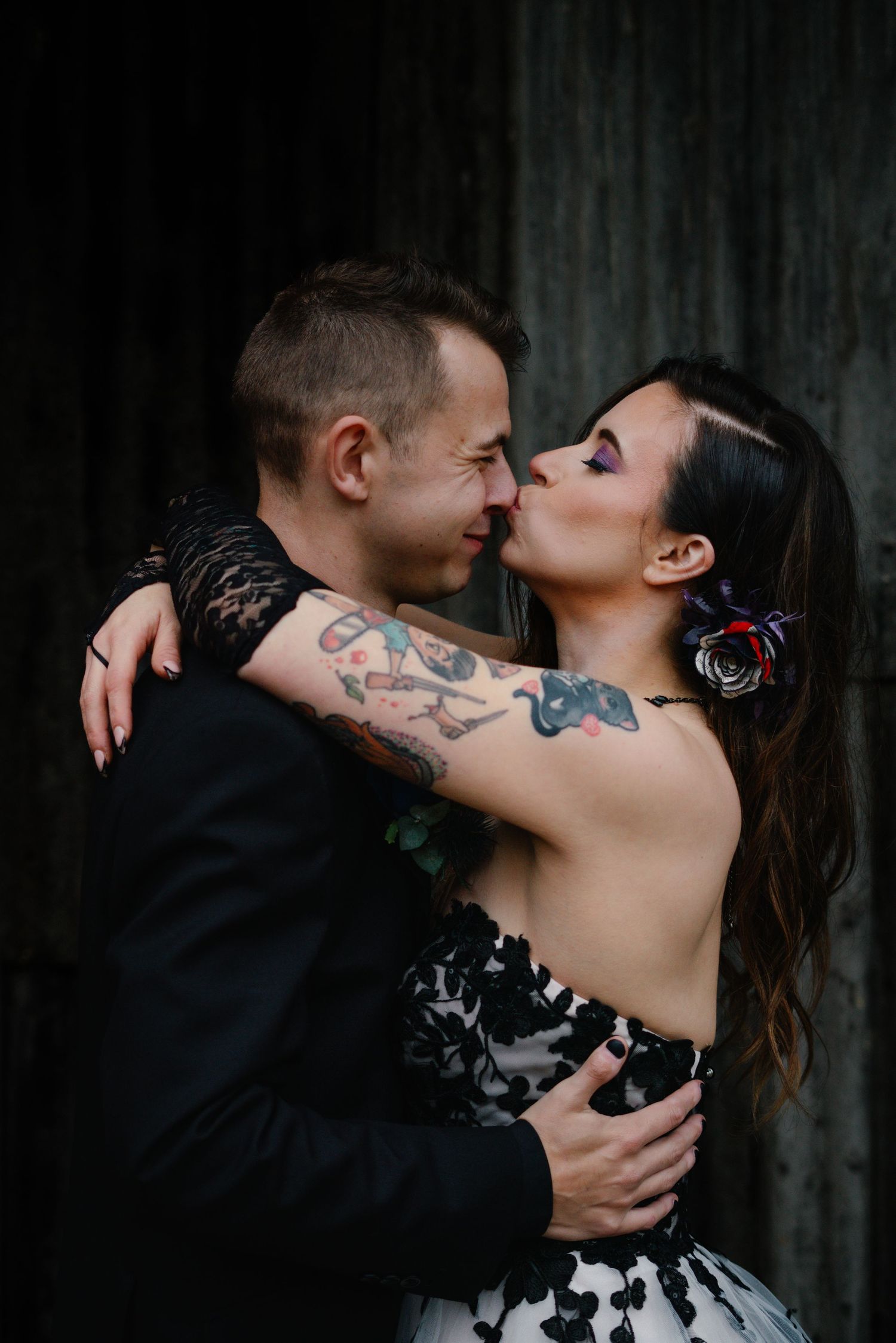 Candid couple portrait of alternative newlyweds kissing passionately at the clock barn wedding venue in Hampshire