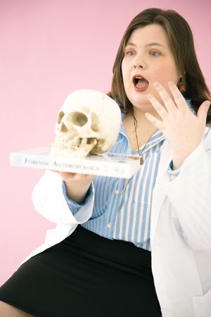 Person in striped shirt and black vest poses with skull prop against pink background in playful photo series.