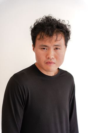 Four identical photos showing a person in a black sweater against a white background arranged in a row.