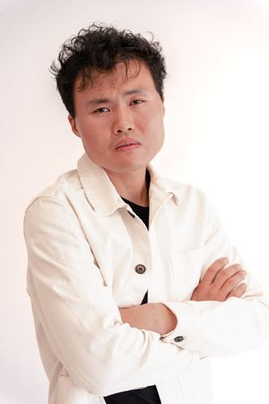 Person wearing a white blazer poses against light background in multiple overlapping artistic portrait shots.