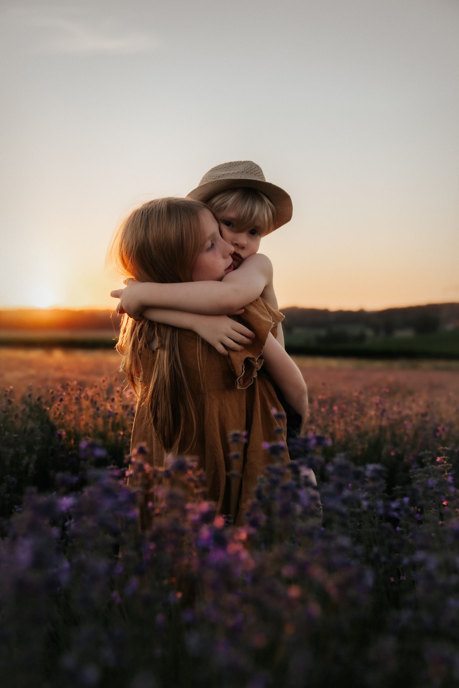 A peaceful moment between parent and child against mountains at sunset.