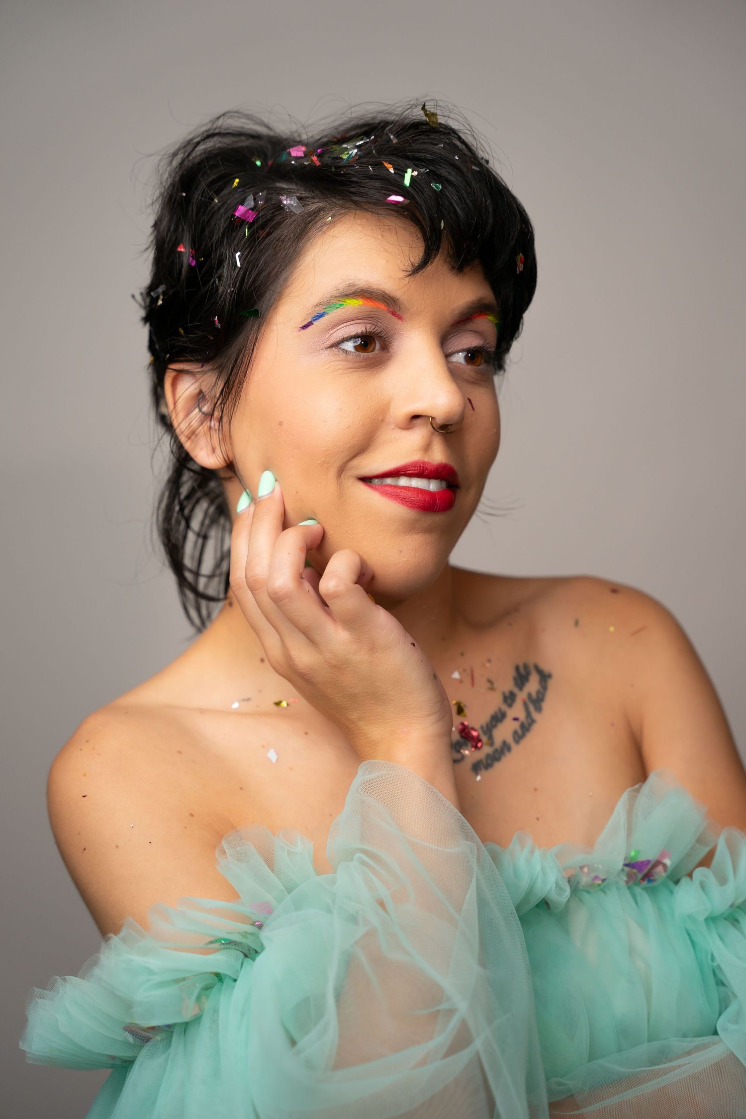 Glamorous poses in a mint green tulle dress with sparkly confetti accents.