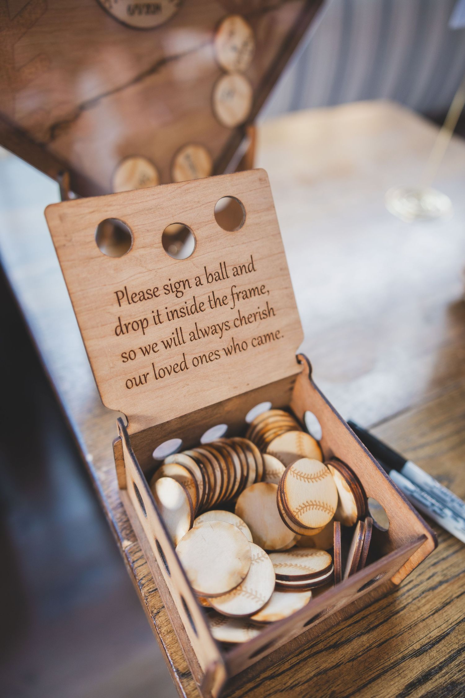 Wooden box filled with commemorative tokens at a wedding reception.