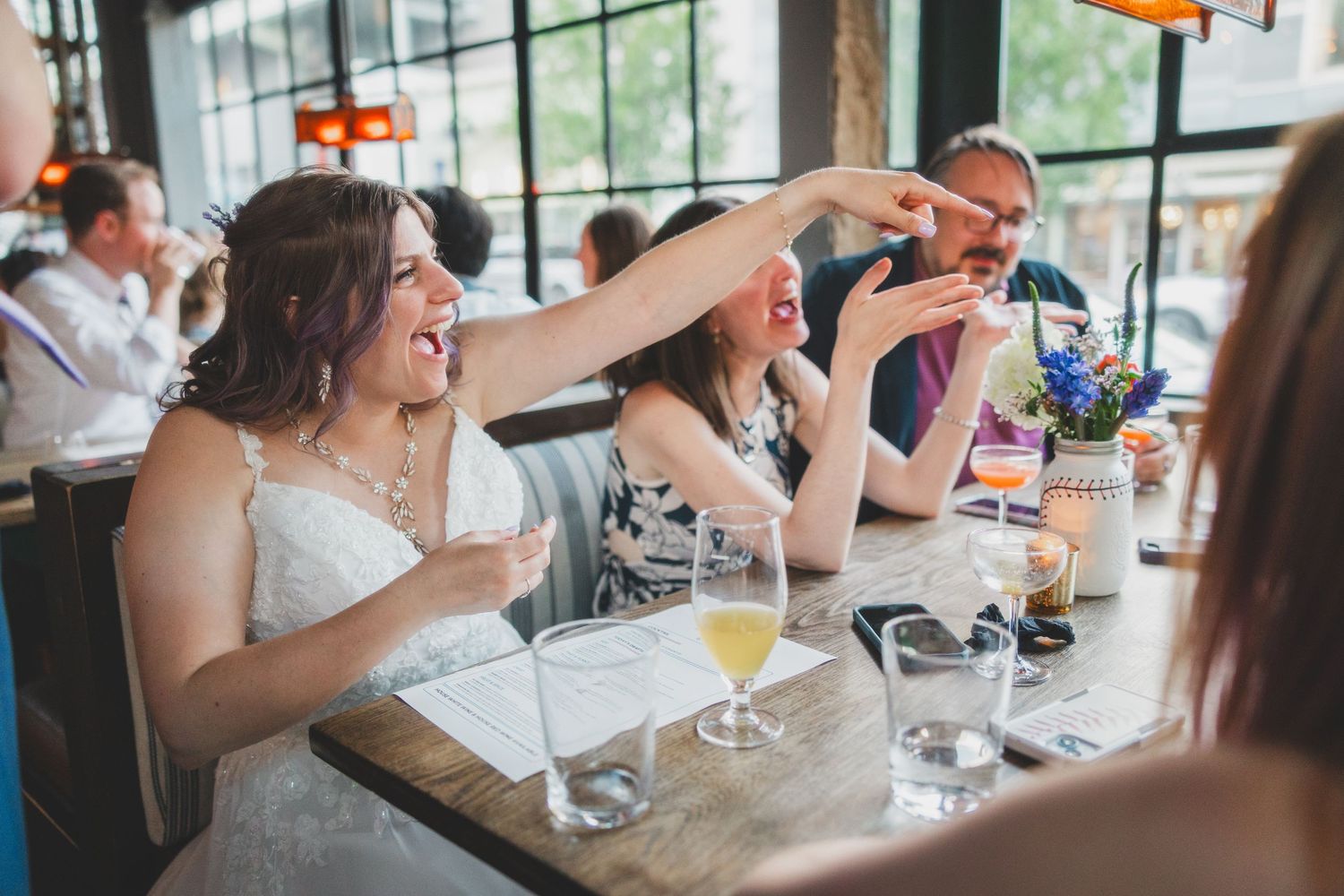 Wedding celebration with drinks at a restaurant table.