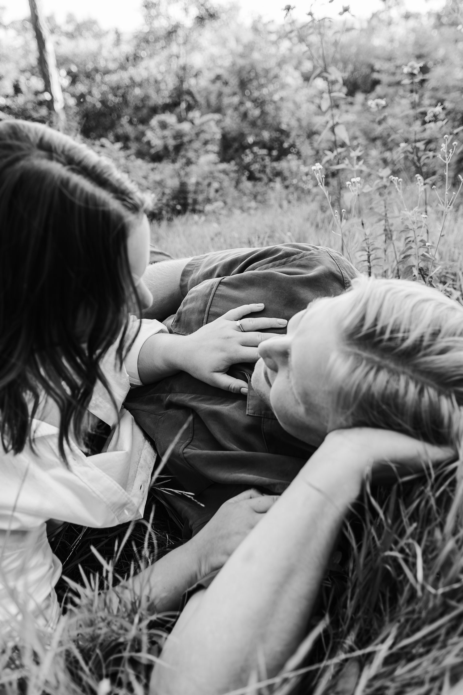 Engagement ring shows clear with couple in the foreground