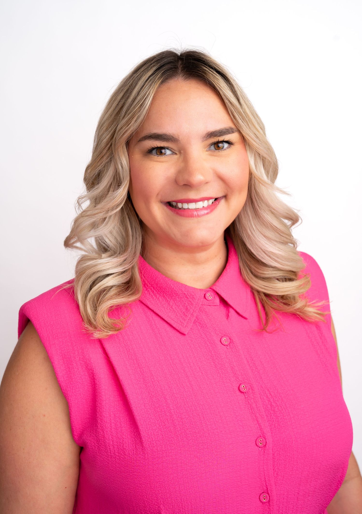 Woman wearing bright pink sleeveless top in progressive headshots against white background.