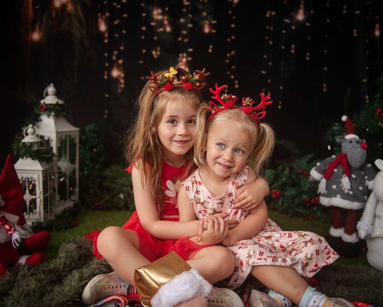 Holiday portraits with festive decorations and twinkling lights in the background.