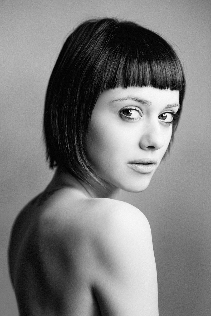 Black and white artistic portrait series showing a short bob haircut from different angles.