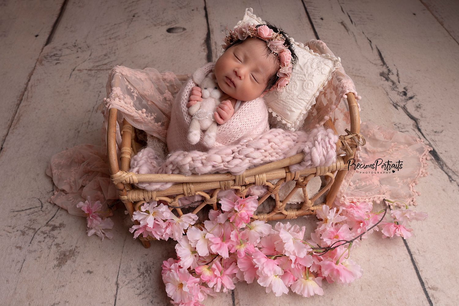 Carefully wrapped and styled in a little newborn prop, peacefully sleeping
