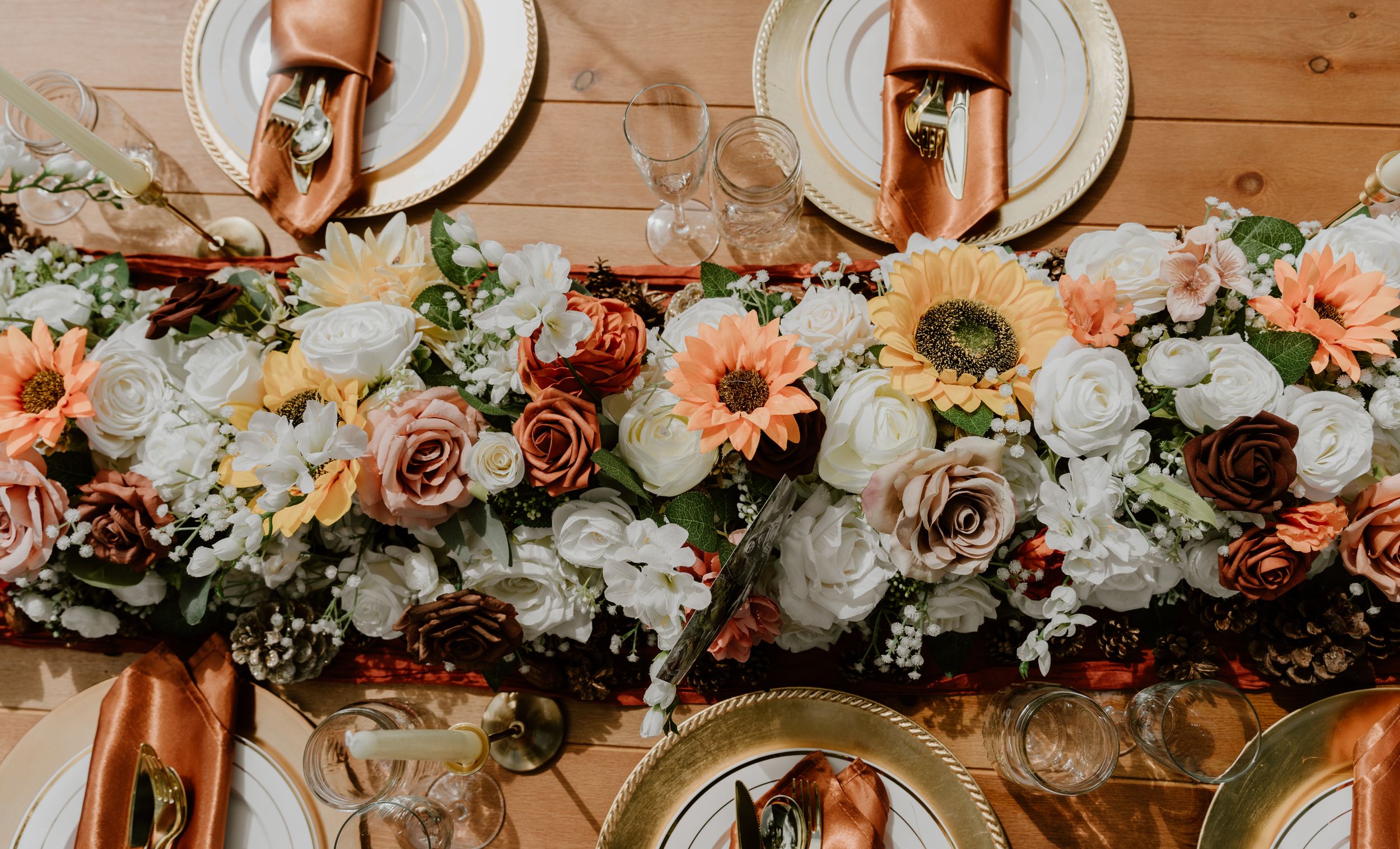 Romantic floral centerpiece with peach and white roses decorating an elegant table setting.
