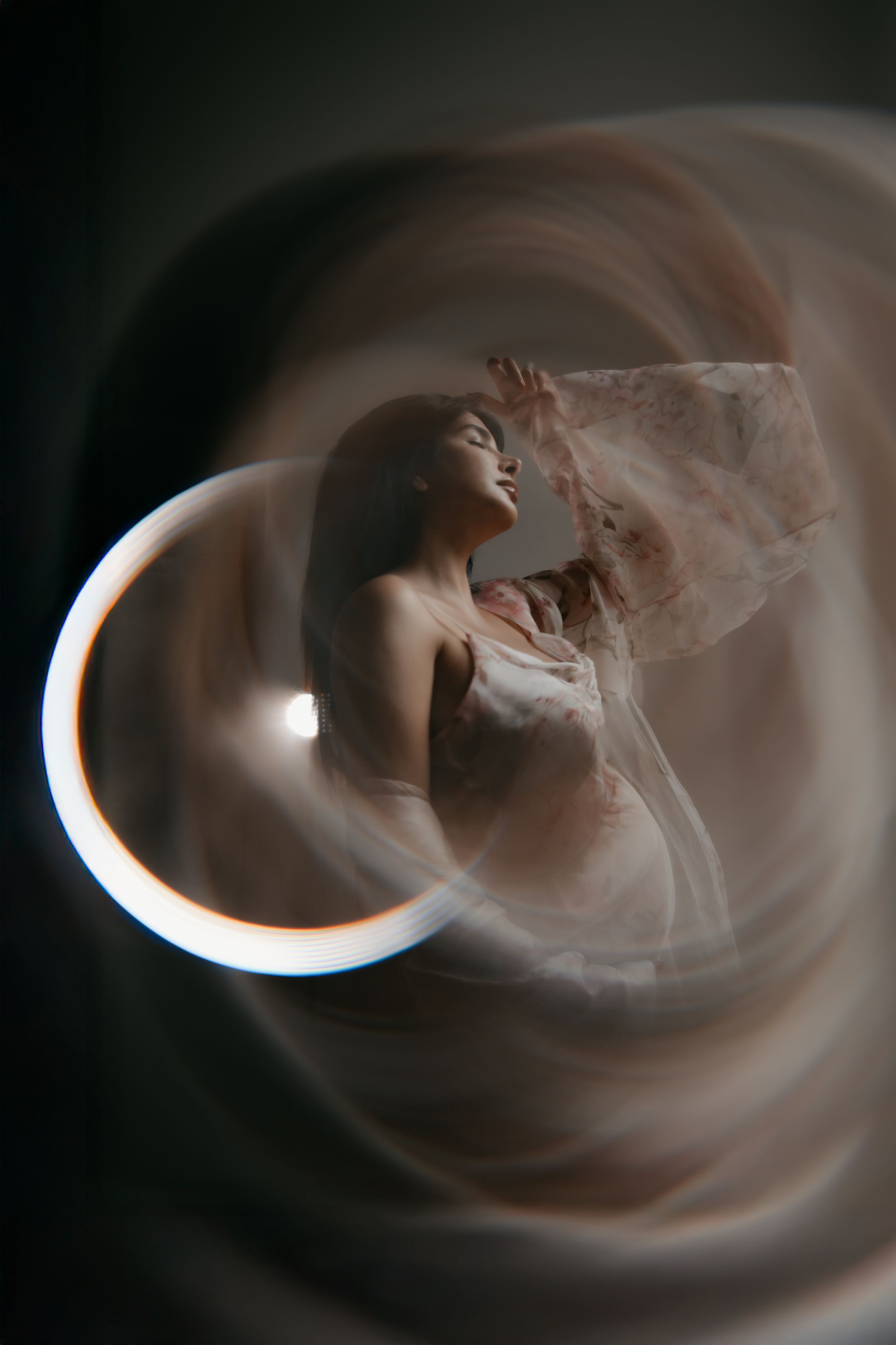 a portrait of a pregnant woman standing in the middle of a faded photo effect
