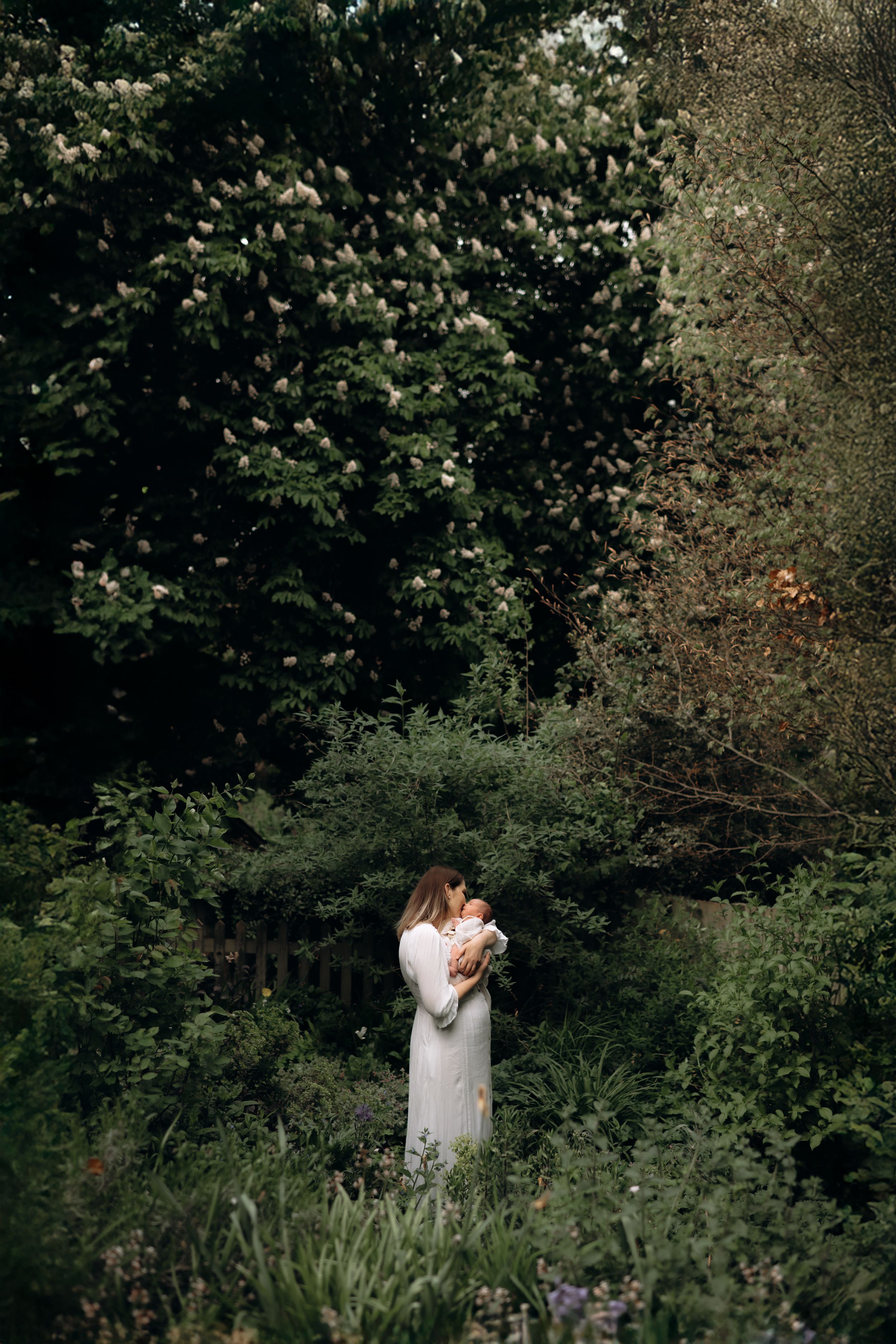a mother holding her baby in her arms kent family photographer