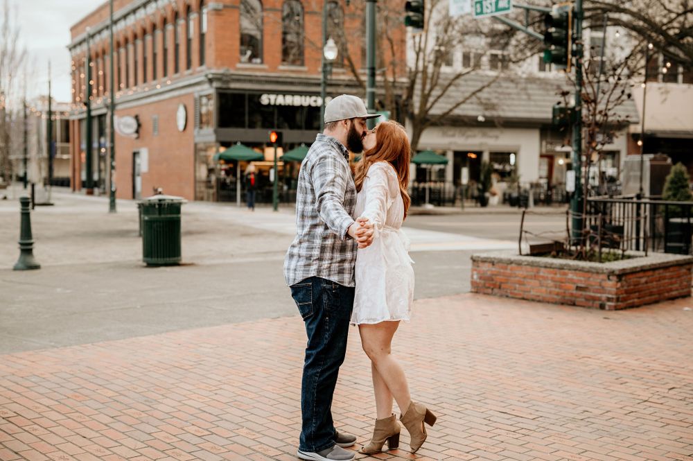 Couple stands in front of Starbucks for their winter engagement session