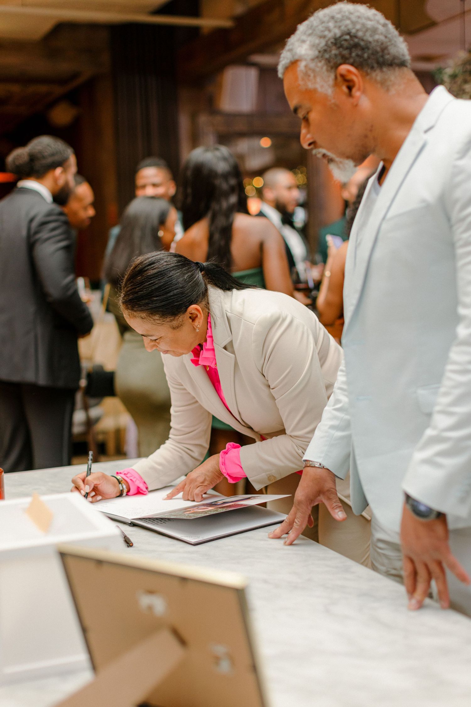 Event guests signing documents at a registration table.