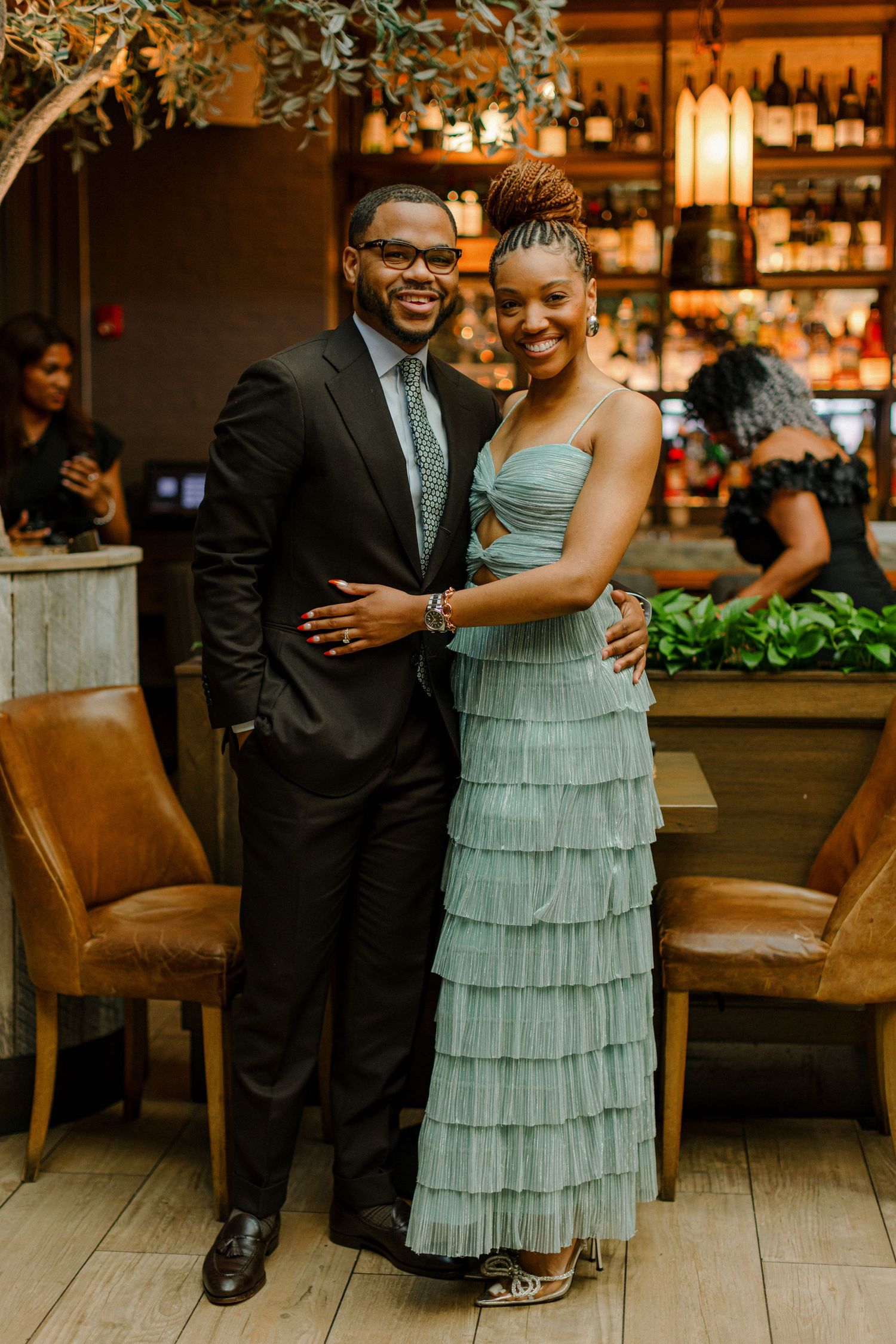 Elegant couple in formal attire at an upscale venue reception.