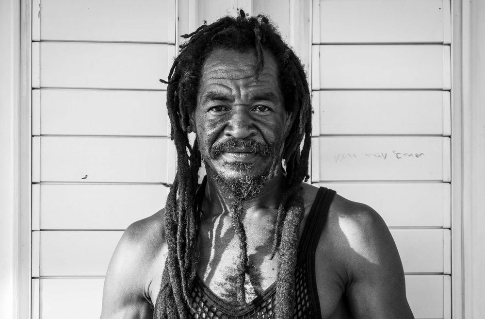 Black and white portrait series showing expressions against white background.