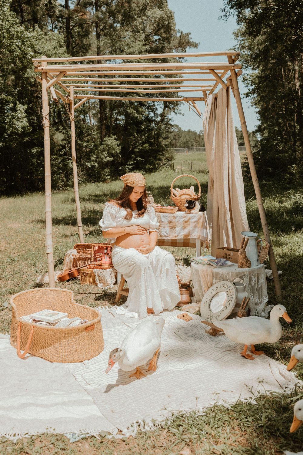 A dreamy outdoor picnic scene with wooden pergola, white blanket, and vintage-style decorations in warm natural lighting.