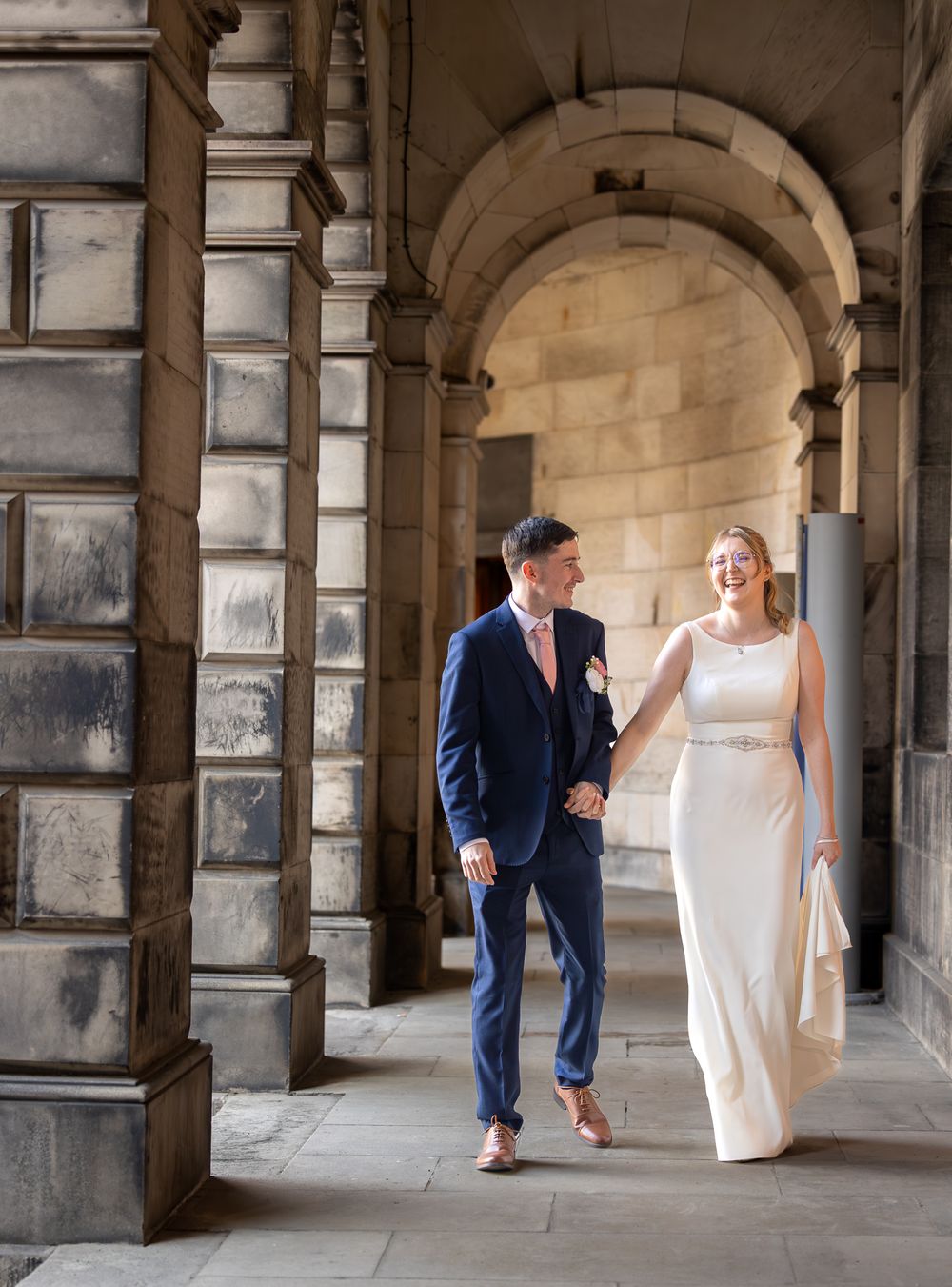 Series of wedding photos in a stone archway shows couple playfully interacting in natural lighting conditions.