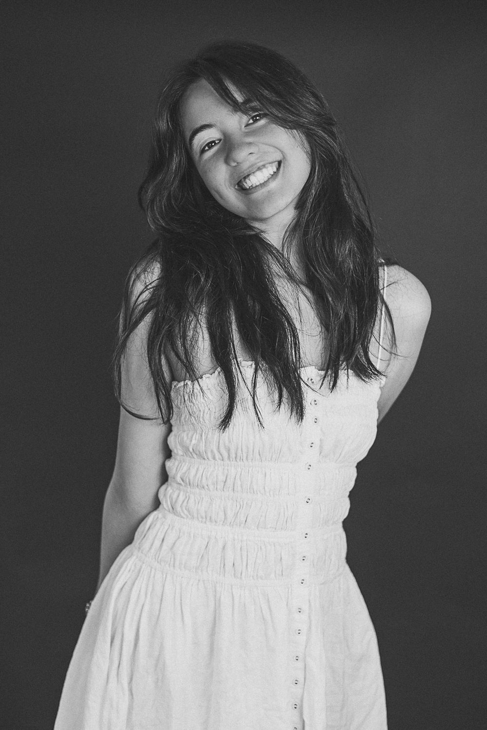 A black and white portrait showing natural joy and movement.