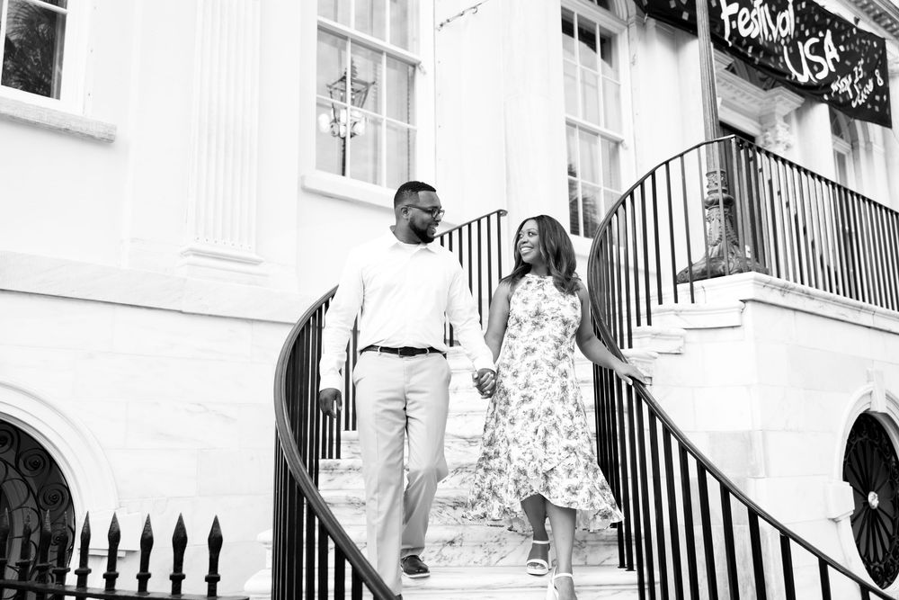 A series of black and white wedding photos showing a couple posing on elegant white stairs with iron railings.