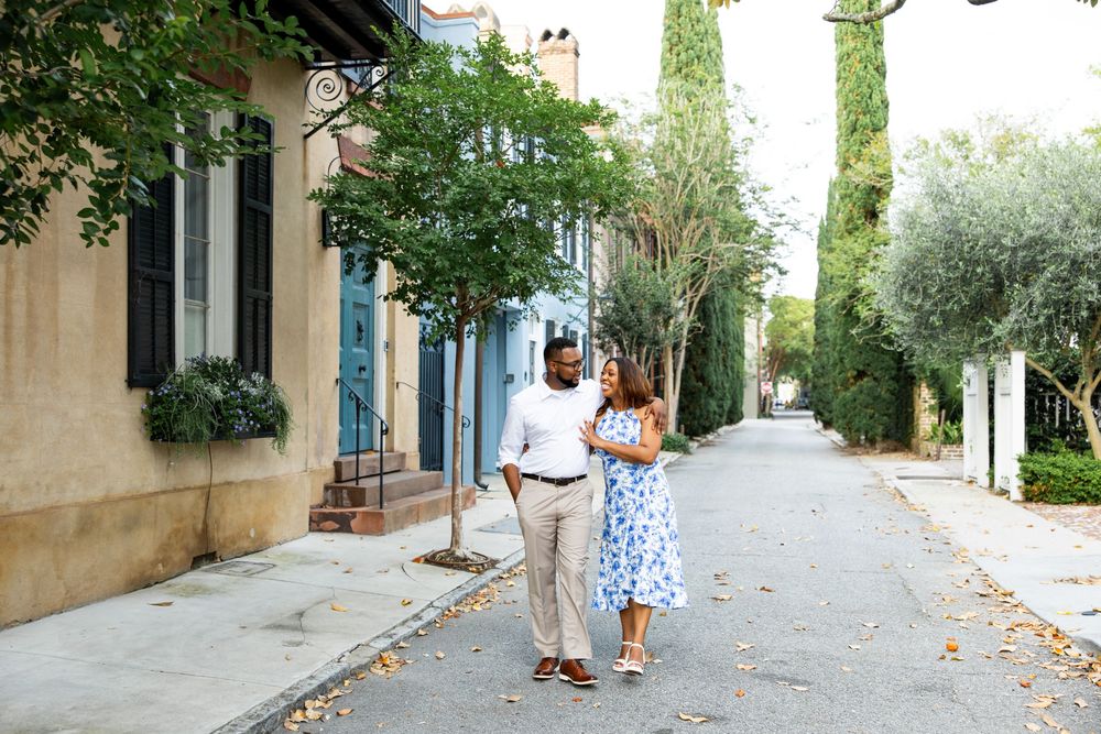 A tree-lined cobblestone street with historic buildings and natural lighting creates a romantic setting.