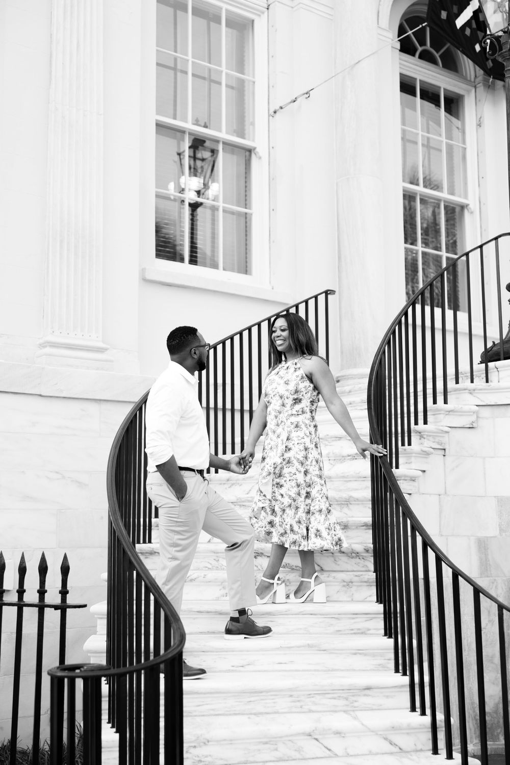 A series of candid moments between a couple on classic white steps with wrought iron railings.