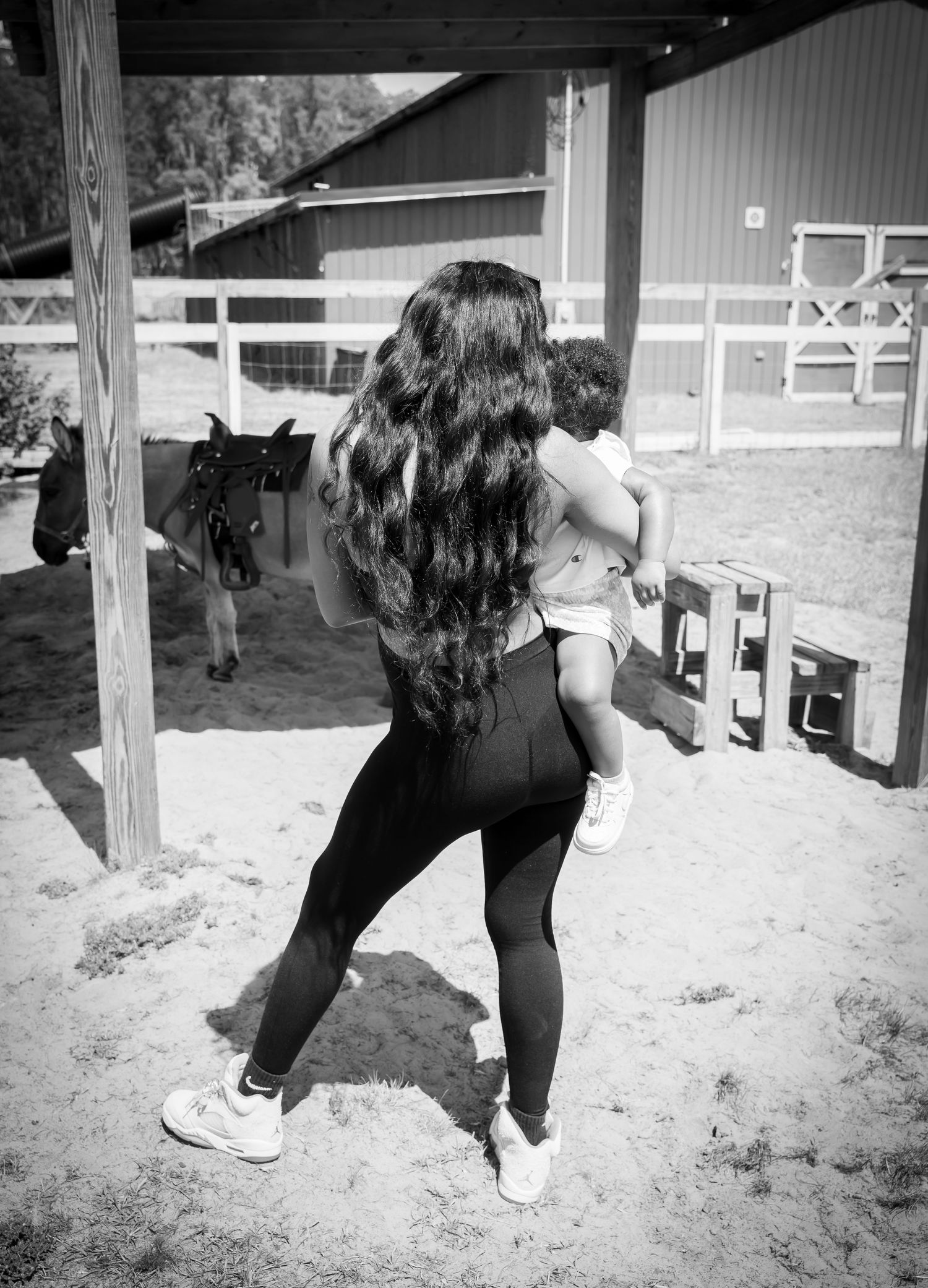 Sequence of someone bending down to pick something up outdoors in black and white photography.