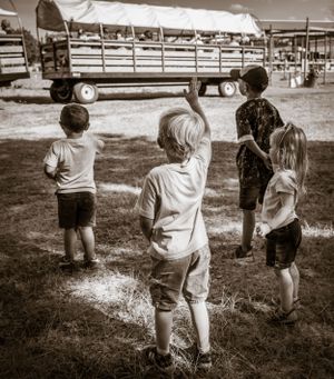 Group walking together on a grassy path in black and white.