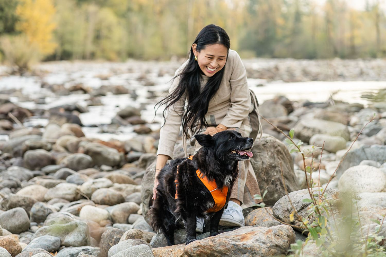 Mother patting her dog at the river in North Bend.