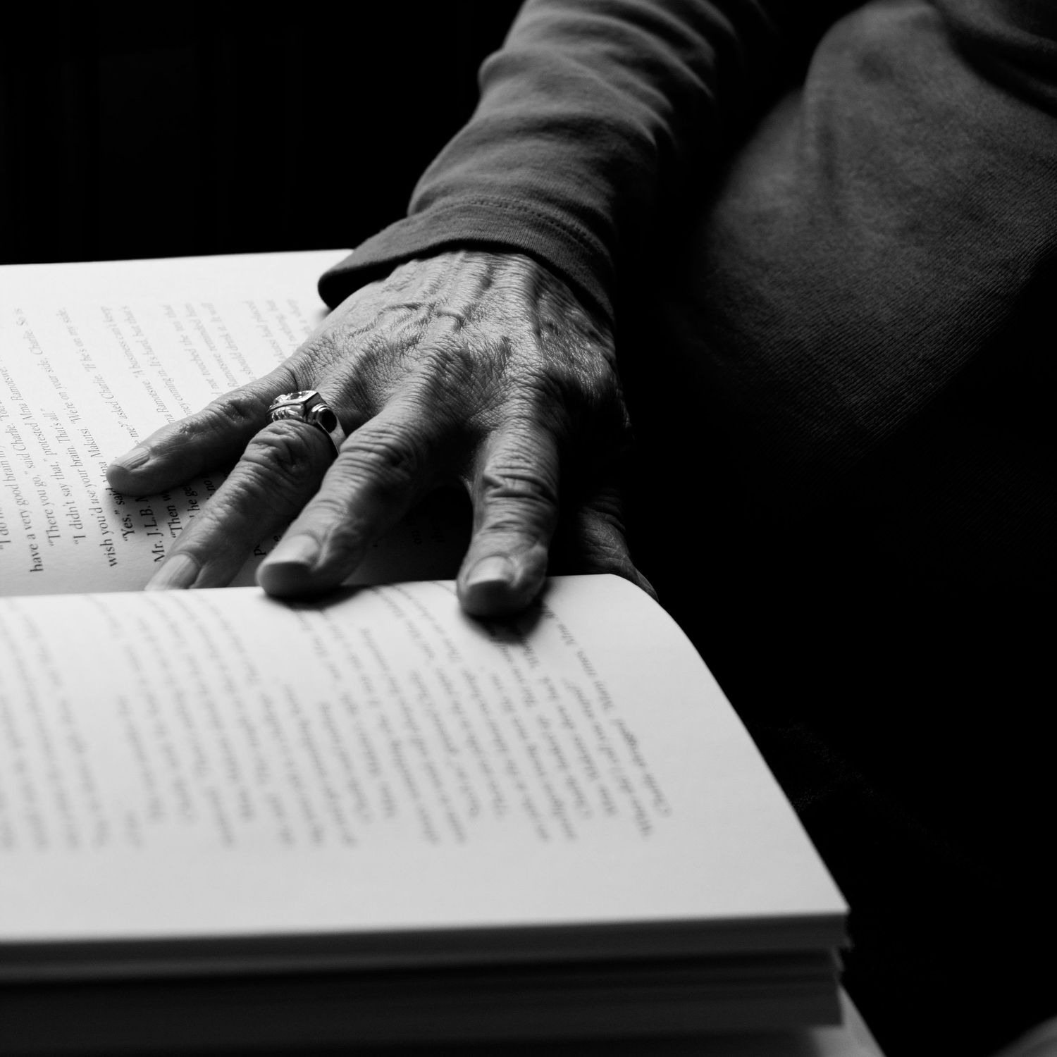 woman's hand on open book