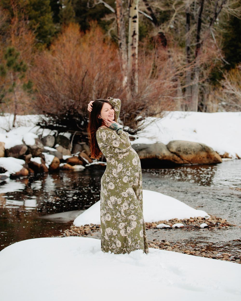 winter maternity portrait of pregnant mom on a snow covered river in Lake Tahoe