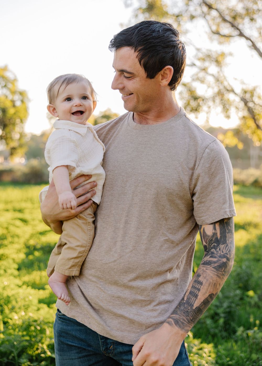 Sweet candid shots of parent and baby playing together in a sunlit field.