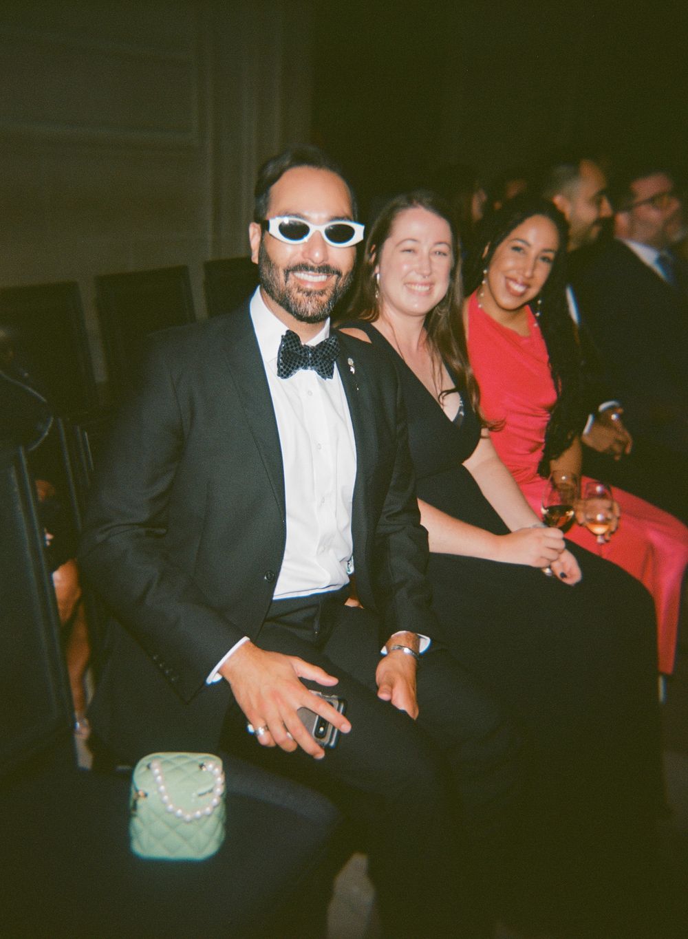 Wedding reception guests enjoying themselves at an evening celebration.