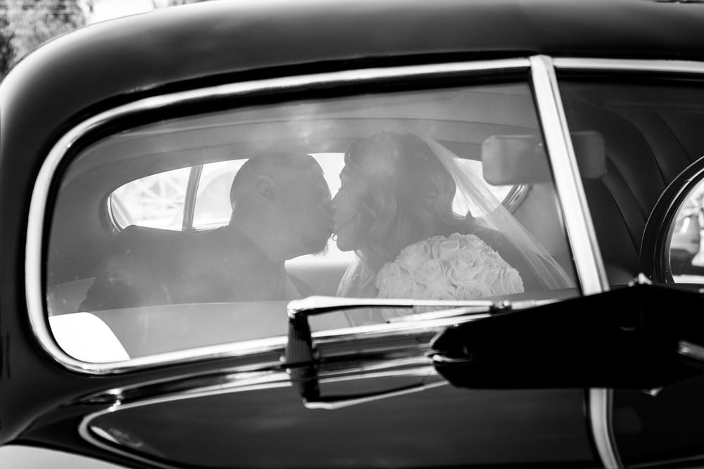 Vintage car interior shot in black and white showing classic dashboard details.