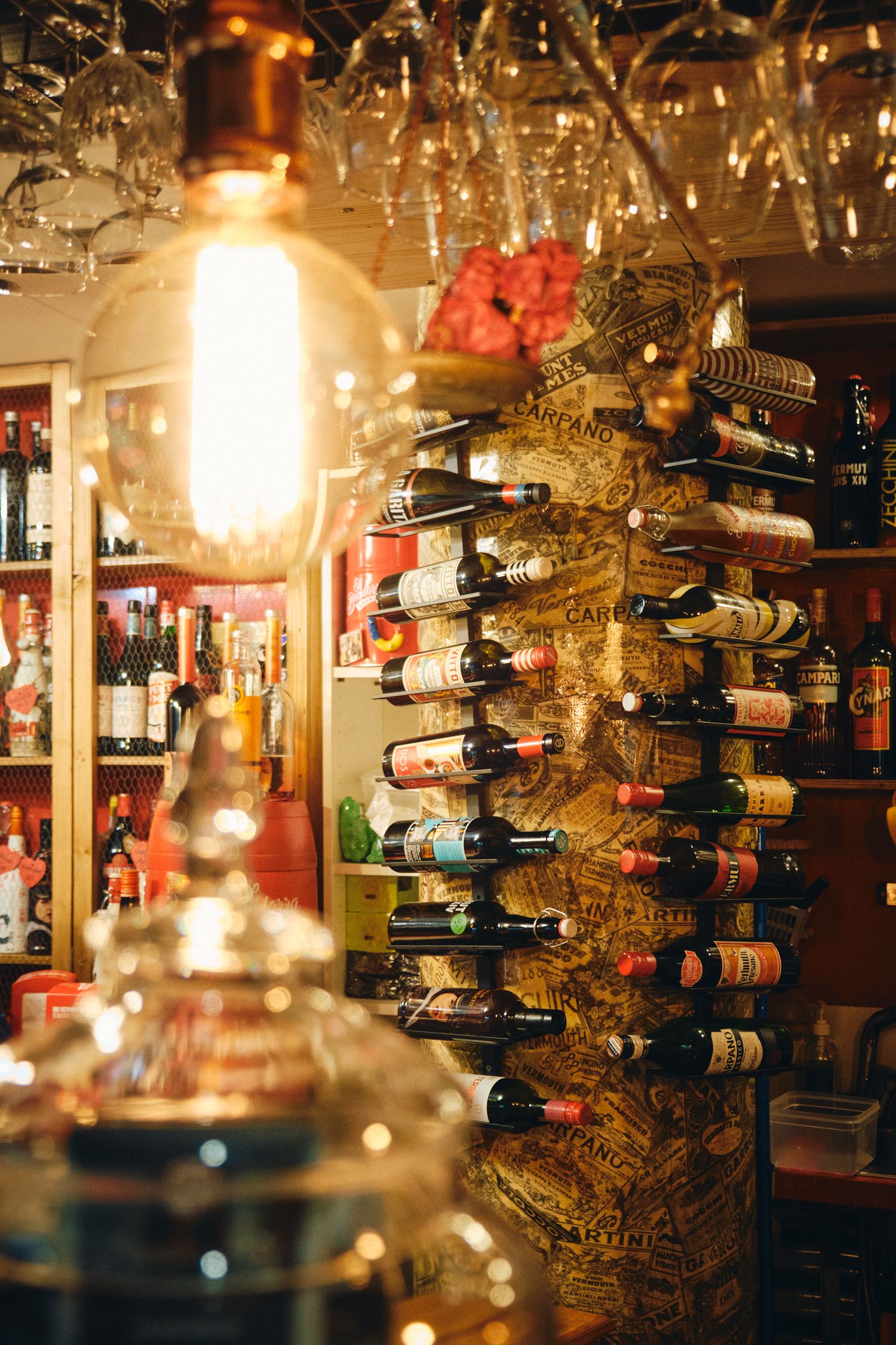 Illuminated wine bar interior with extensive bottle collection on display.