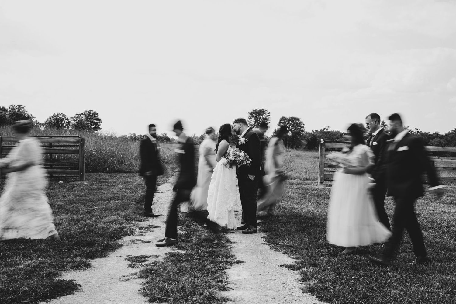 Vintage black and white photo of couples dancing at outdoor wedding reception.