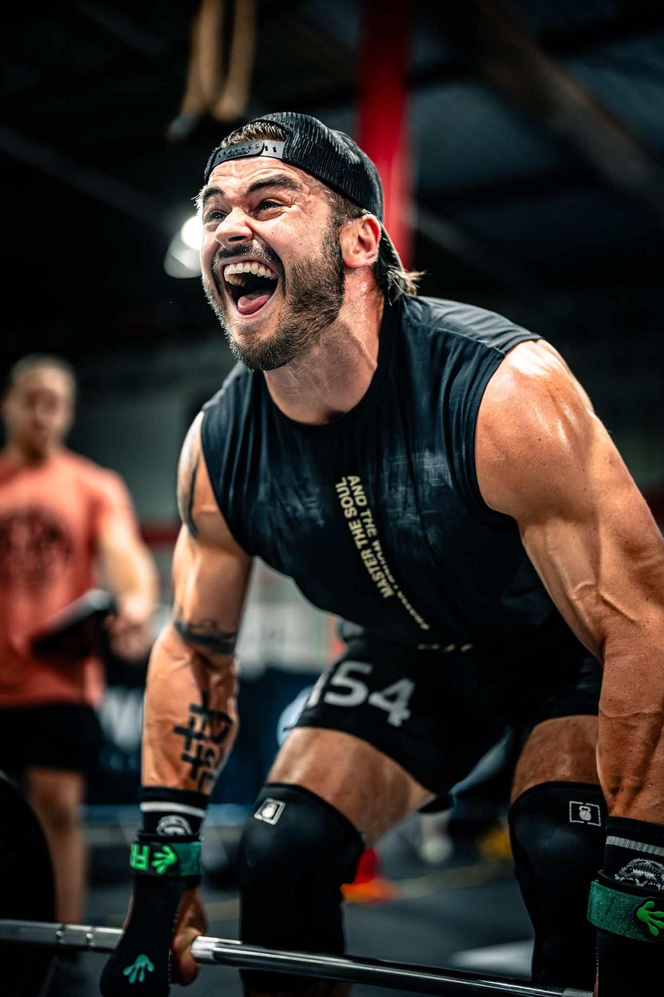 Athlete performs intense workout exercises at CrossFit gym.