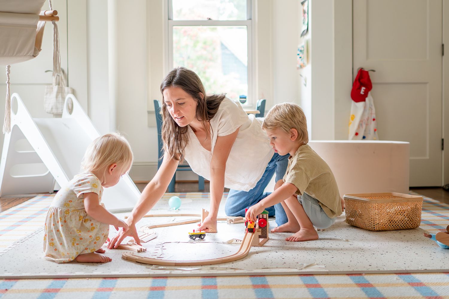 Family plays in the playroom during an at-home family session in Winston-Salem.