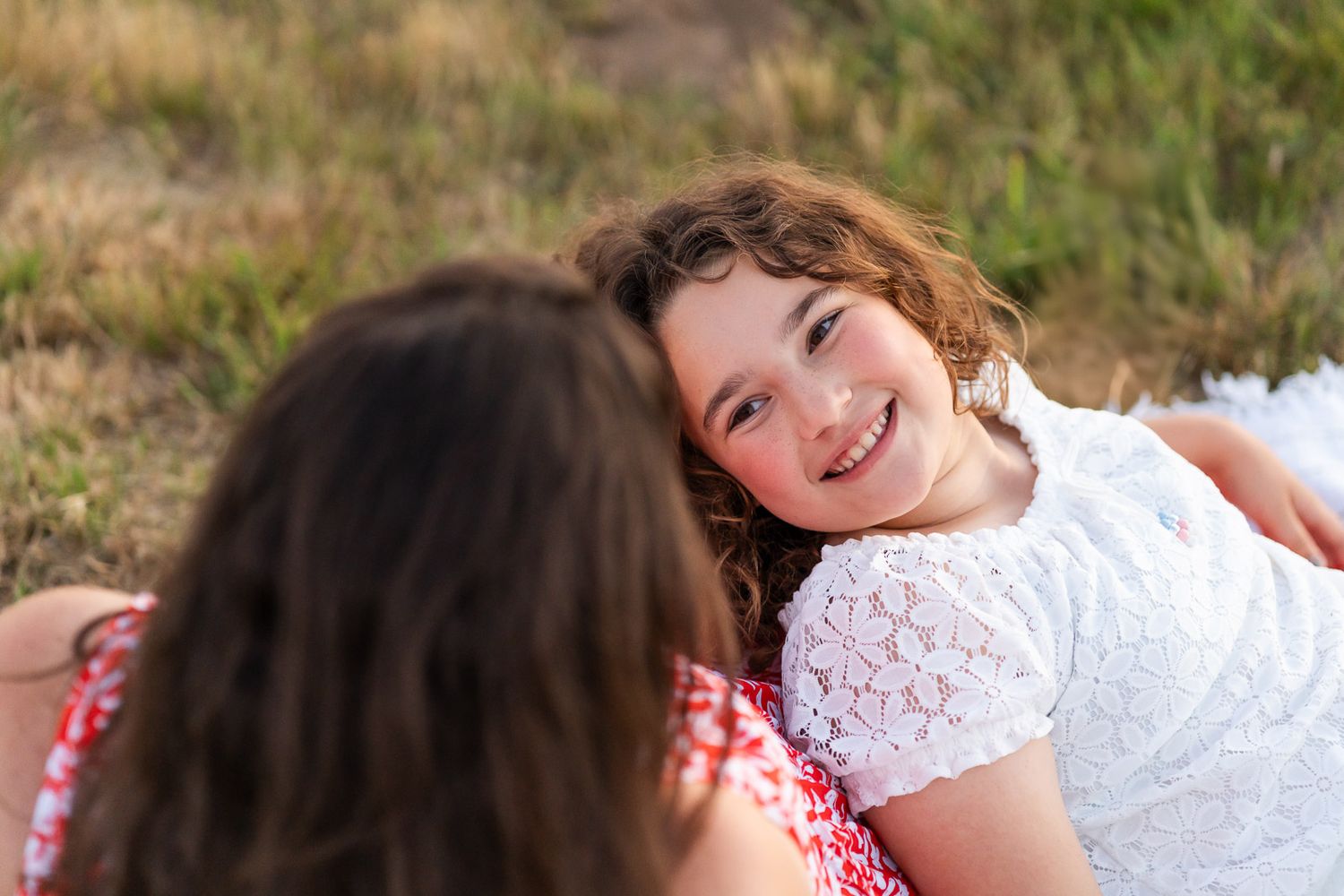 Daughter looking up at mother smiling at Marymoor Park