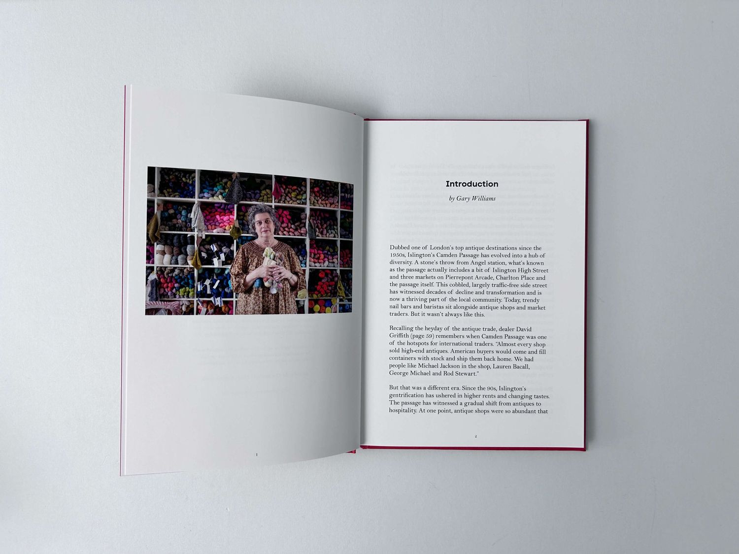 An open book showing a grid of photos on one page and text on the opposite page about Camden Passage