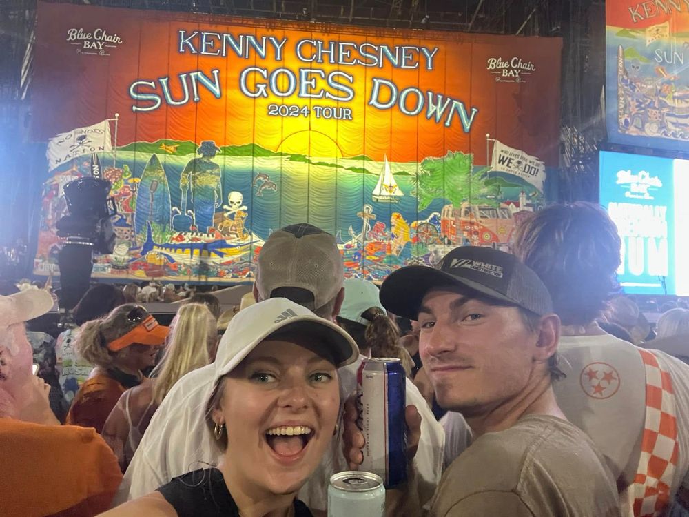 Celebratory scene at a Kenny Chesney 'Sun Goes Down' themed bar or restaurant event.