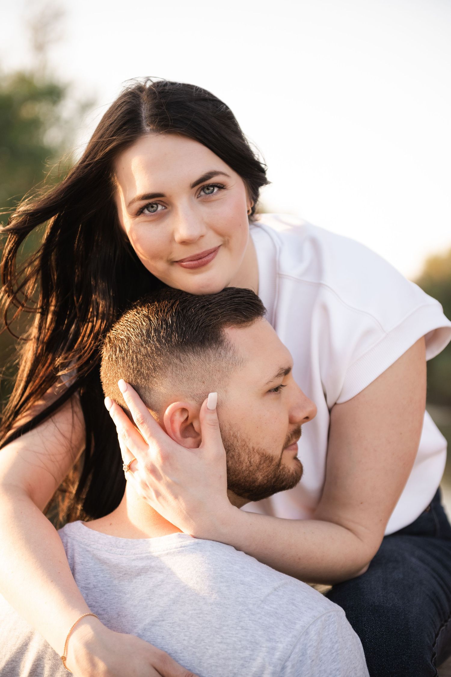 An intimate couple's portrait captured in warm sunset lighting.