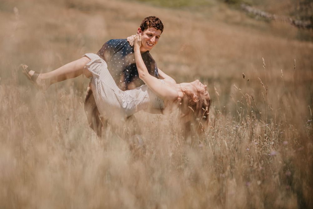 A playful moment captured in a golden field during summer.
