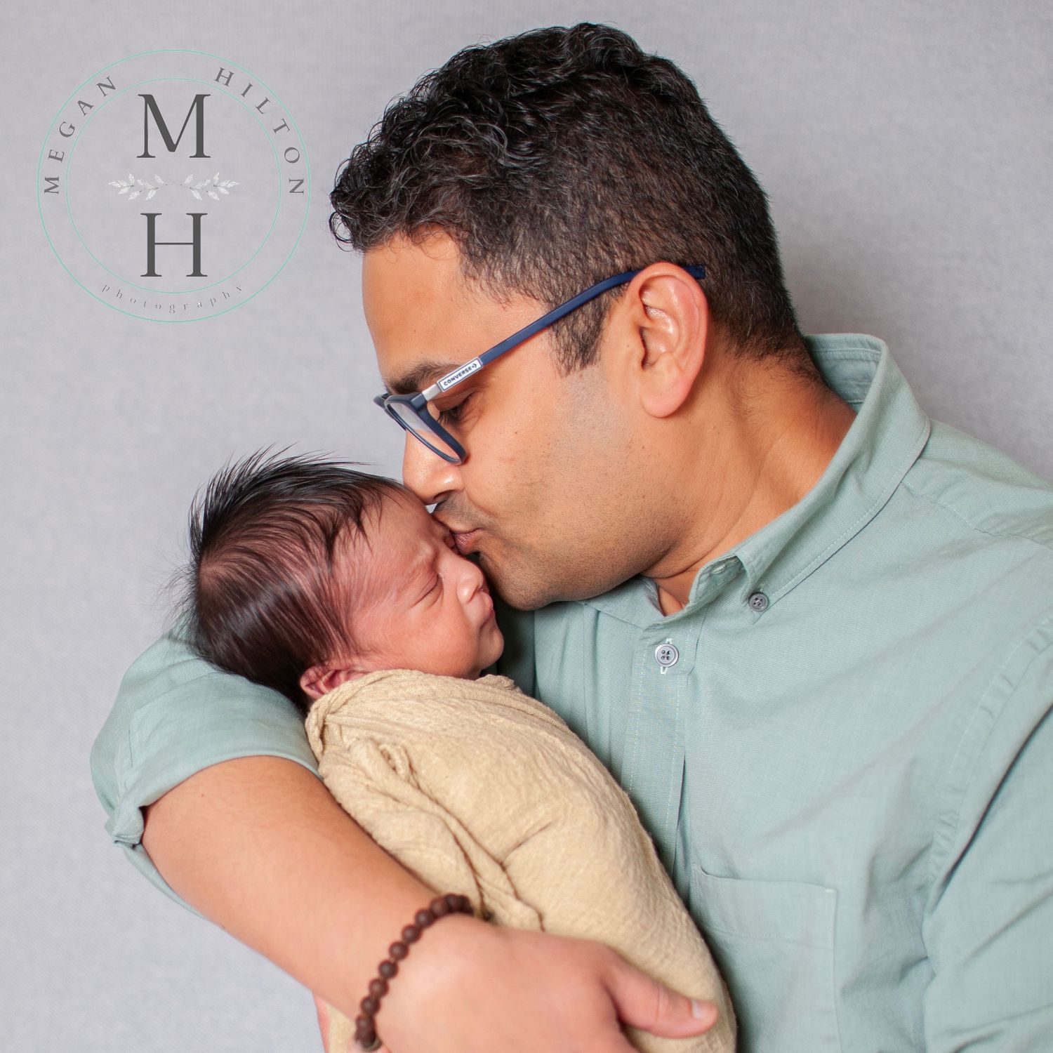 Dad kissing newborn image