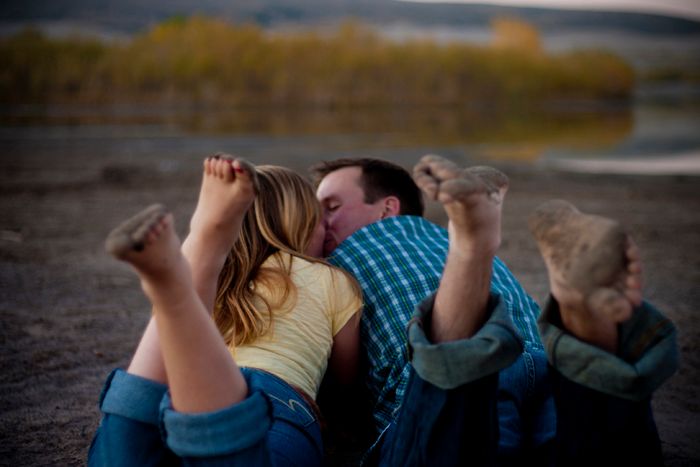 A casual outdoor portrait showing people laying down together at sunset.