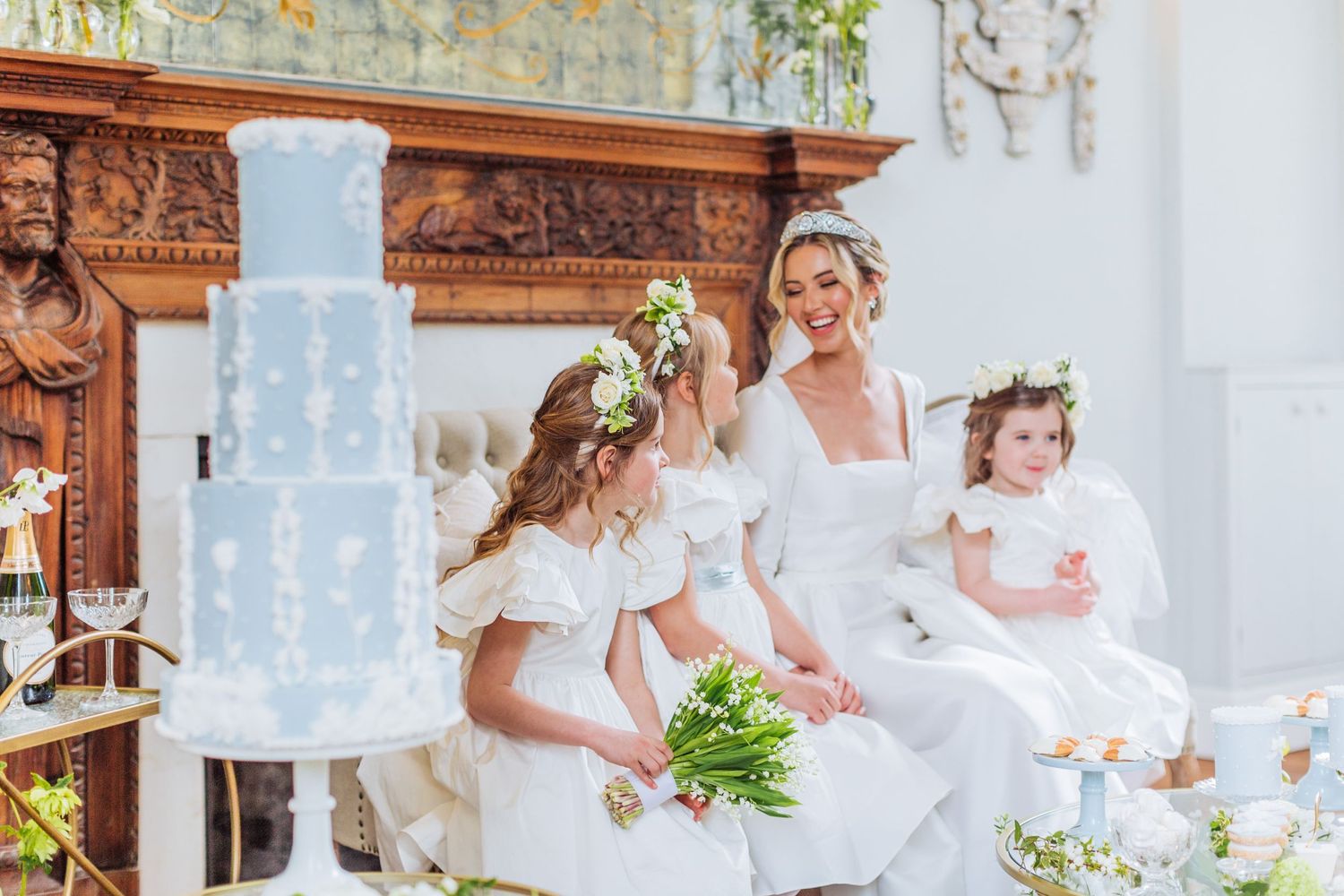 Hayley Elizabeth luxury wedding photographer Cornwell manor the cotswolds photography bride laughing with flower girls