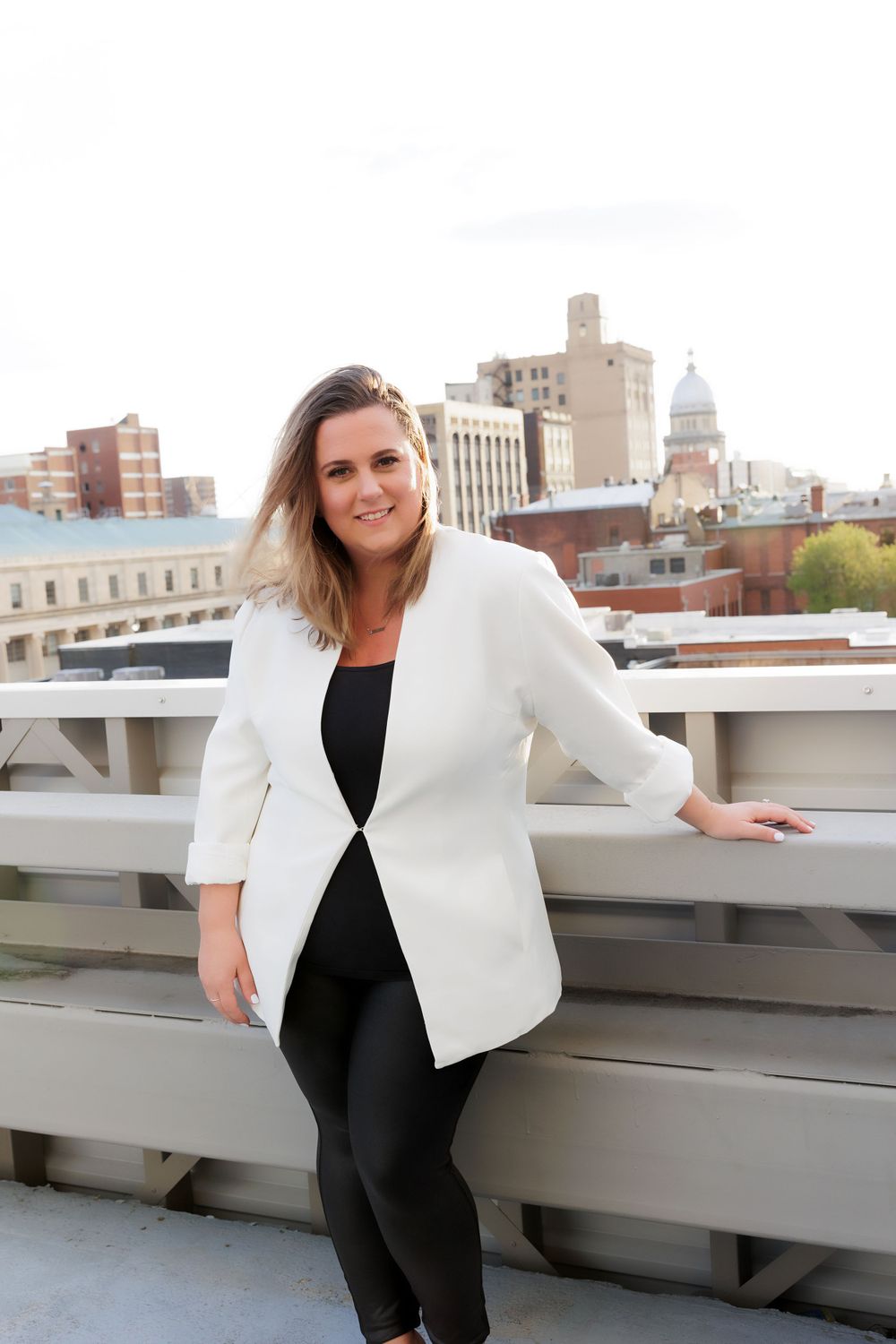 Fashion forward business attire showcased against urban architectural background on rooftop.