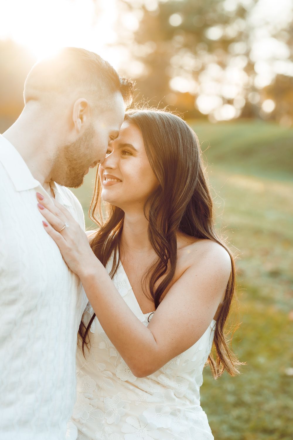 Intimate engagement photo of couple in white attire during golden hour. Pittsburgh Wedding Photography, Videography